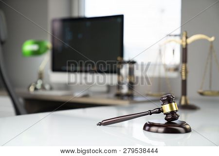 Lawyers Office. Gavel, Scale And Computer On The White Table.
