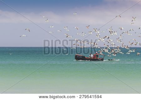 Paternoster, South Africa - 22 December 2018: Sea Fishing Boat With Two Fishermen And Their Catch Wi