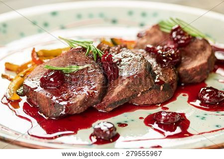 Grilled Veal With Smashed Cherries, Closeup. Veal With Smashed Cherries, Rosemary And Yellow Pepper.