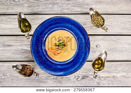 Delicious Cream Soup With Crayfish Tails And Vegetables, Top View. Cream Soup With Crayfish In Blue 