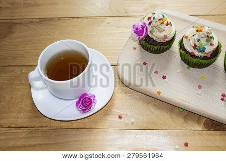 Muffins On A Wood Cutting Board. Cream Decoration. Tea. Place For Text.