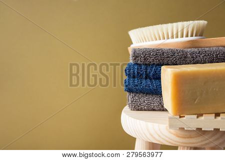 Hand Crafted Artisan Olive Oil Soap Body Brush Folded Cotton Towels Stacked On Wooden Chair Painted 