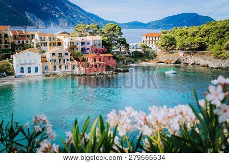Bright White Flower Blossom In Front Of Turquoise Colored Bay In Mediterranean Sea And Beautiful Col