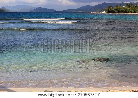 Waves Rolling On A Small Sandy Beach Of St Thomas Island, Usvi. Cloudy Skies On And Faraway Smaller 