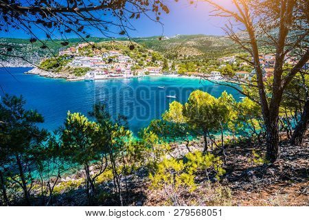 Pine Tree Grove Branch Frame View Of Mediterranean Sea Bay In Colorful Assos Village. Kefalonia Gree