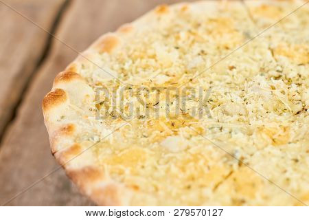 Shredered And Melted Cheese Ans Spices On Pizza Crust, Macro View. Round Pizza Crust, Close Up View.