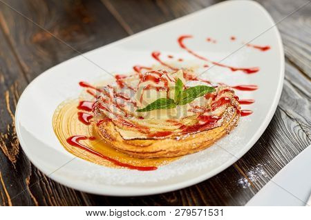 Apple Tart With Ice Cream, Jam And Mint. Sweet Dish, Wavy Poured Red Sauce.