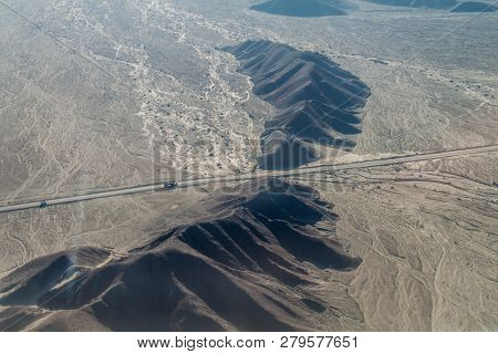 Aerial View Of Geoglyphs Near Nazca - Famous Nazca Lines, Peru. Panamericana Highway Is Crossing Thi