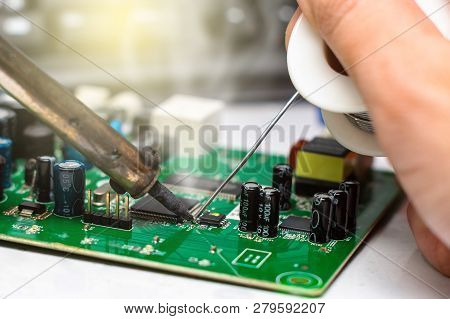 Close Up Of Microelectronics Engineering. Soldering Lead Repairing Computer Board Technology Concept
