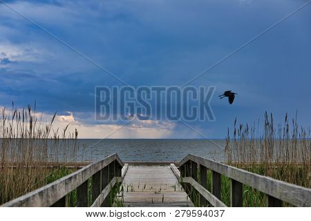 The pier in Currituck Heritage Park in Corolla on the Outer Banks in North Carolina is a popular tourist attraction.  This location is on the sound in this historic area of the OBX.