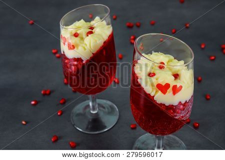 Dessert Panakota And Red Jelly And Pomegranate Seeds On Rustic Wooden Table