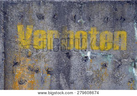 Word verboten (German - forbidden) on old concrete surface