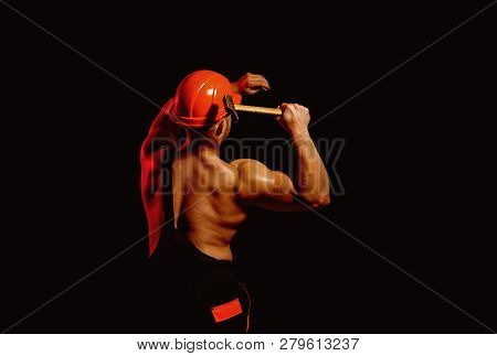 Already Under Construction. Construction Worker Hammer A Nail. Muscular Man Builder At Work Under Co