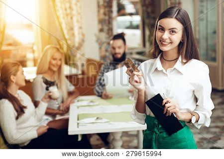Portrait Smiling Young Waitress Standing In Cafe. Waiter Serving Concept. Calculation Of The Order I