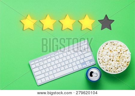 Bowl Of Popcorn, A Can Of Drink, A Keyboard On A Green Background. Added Four Stars Rating. Reputati