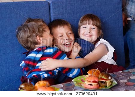 Kids In A Cafe Learning How To Cook Burgers