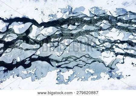 Aerial View On The River At The Winter Time. Natural Winter Landscape From Air. River Under Snow A T