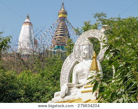 Buddha Sculpture At The Southeastern Foot Of The Swayambu Hill On A Background Of Swayambhunath Temp