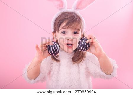 Portrait Of A Little Girl With Bunny Ears And Easter Eggs