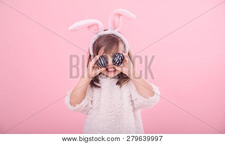 Portrait Of A Little Girl With Bunny Ears And Easter Eggs