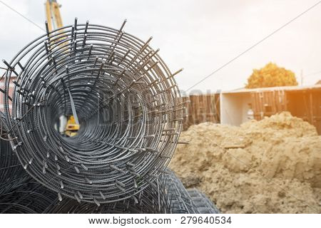 Rolls Of Wire Mesh Steel For Construction Put A Pile On The Ground, Against Construction Site Backgr