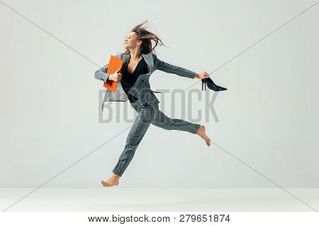 Happy Business Woman Dancing And Smiling In Motion Isolated Over White Studio Background. Human Emot