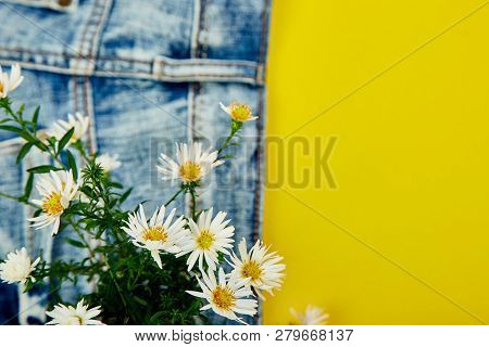 Bouquet Of White Flower In The Pocket Of A Jeans