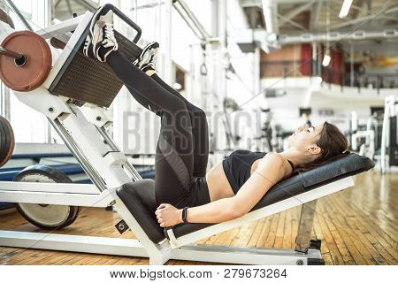 Young Women Doing Legs Press Exercise