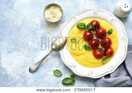 Traditional Italian Dish Polenta With Parmesan Cheese And Grilled Tomato.