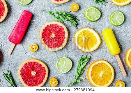 Citrus Slices With Fruit Popsicles On Table Background Top View Pattern