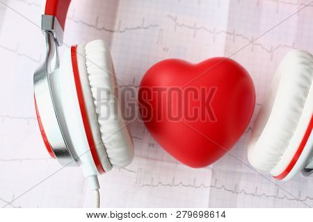 Red Toy Heart An Heaphones On Paper Cardiogram Background Closeup Concept