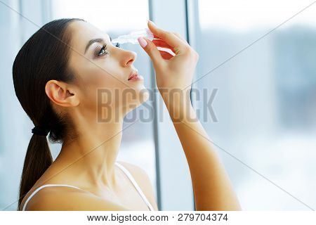 Health And Beauty. Beautiful Young Girl With Eye Drops. Woman Holds Eye Drops In The Hand. Healthy L