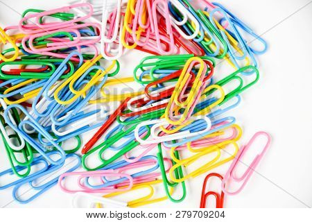 Top View Mix Colorful Paper Clips  On White Background. Color Clips For A Papera ,device Used To Hol