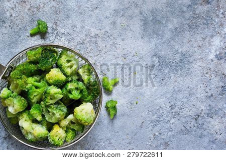 Frozen Broccoli On A Concrete Background With Space For Text, Healthy Diet Food. View From Above