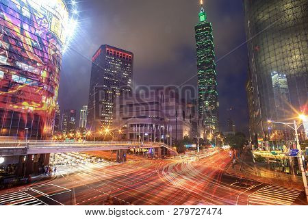 Night Light Cityscape Of Taipei 101 Skyscraper With Light Trial In The Street