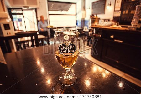 Seville, Spain - Nov 15: Glass Of Lager Beer Estrella Galicia On Table Of Empty Old Style Restaurant