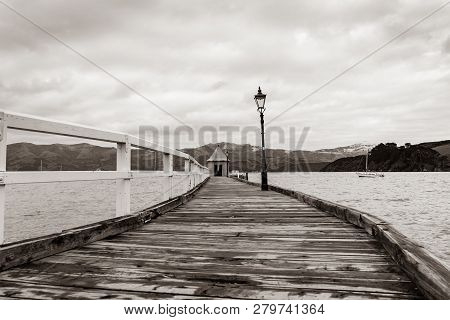 Akaroa Jetty With Shed And Orange Round Conical Roof At End