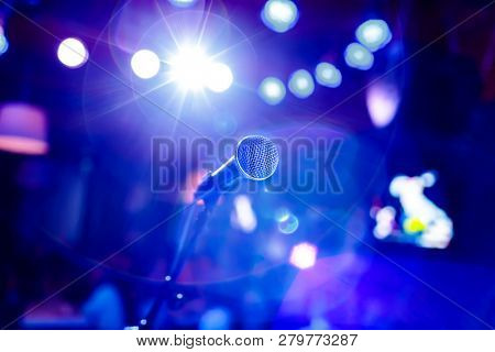 Public performance on stage Microphone on stage against a background of auditorium. Shallow depth of field. Public performance on stage.