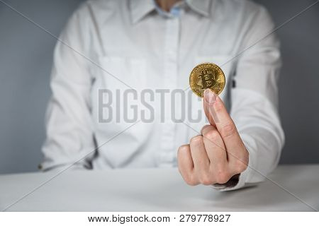 Golden Bitcoin In A Man Hand, Digitall Symbol Of A New Virtual Currency