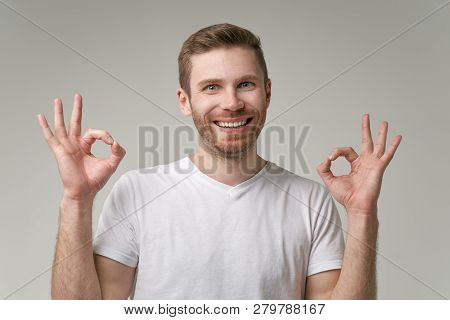Positive Man Shows Ok Sign, Demonstares That Everything Is Fine. The Guy With The Beautiful White Te