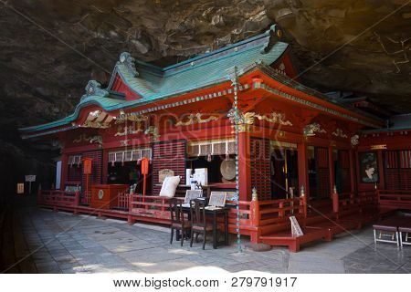 Miyazaki, Japan - November 6, 2018: The  brightly painted Udo Shrine is set in a cave on the side of a cliff overlooking the ocean 