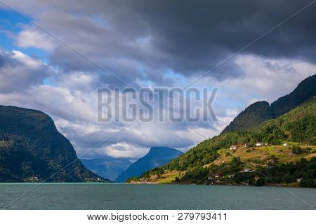 Cloudy sky over the Lustrafjord or Lustrafjorden fjord, branch of greater Sognefjord or Sognefjorden (the King of the Fjords), Luster municipality, Sogn og Fjordane, Norway, Scandinavia