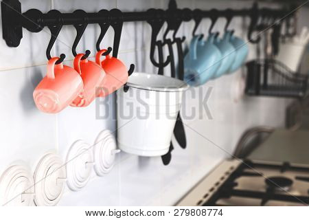 Interior Design Of Stylish Wall In The Kitchen With Some Blue And Coral Cups In A Row. Home Slyle Co