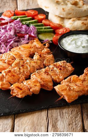 Traditional Taouk Chicken Kebab With Fresh Salad, Yogurt Sauce And Pita Bread Close-up. Vertical