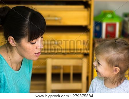 Child Listening To Teacher With Great Pleausure And Interest