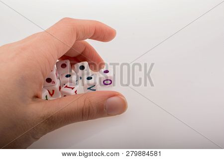 Colorful Alphabet Letter Cubes In Handon A White Background