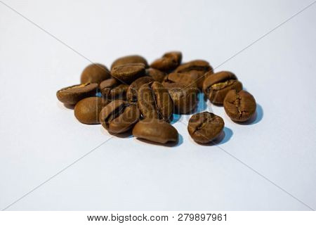 A Few Grains Of Coffee On A White Background