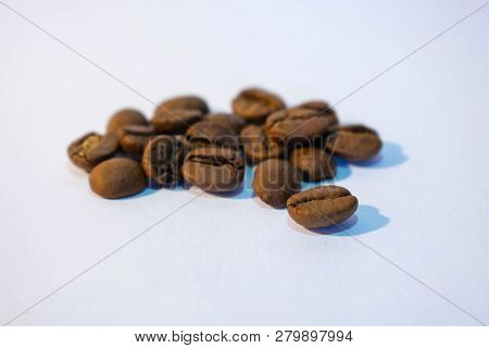 A Few Grains Of Coffee On A White Background