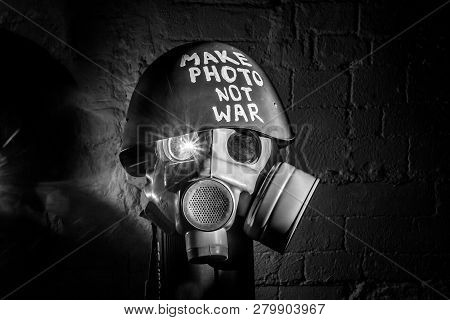 Art Picture Of A Military Gas Mask On A White Brick Wall With Shadows With Flash With The Inscriptio