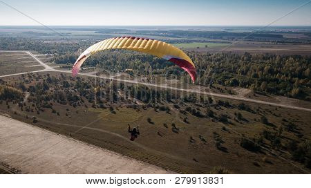Paraglider Flies Over Fields. High Altitude. The Athlete Turns The Thermal Current. Rise Up. Weather